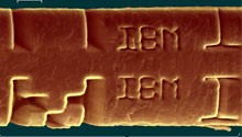 Figure 5'IBM' etched into a human hair with the excimer laser